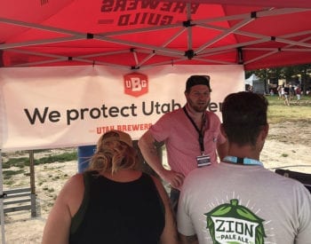 Rio Connelly, president of the Utah Brewers Guild and owner of Proper Brewing Co., chats with folks at the Utah Beer Festival in August 2018.