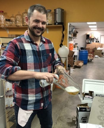 Cody McKendrick, co-owner of Salt City Brew Supply, prepares beer for a Beer Sensory Evaluation class.