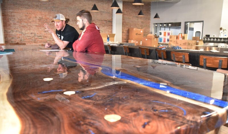 The restaurant centerpiece is a 20-foot walnut island with a river-like blue streak running through it. The piece — as well as a similar 24-foot bar top — was handmade by UTOG Brewing partner Jack Hubble.