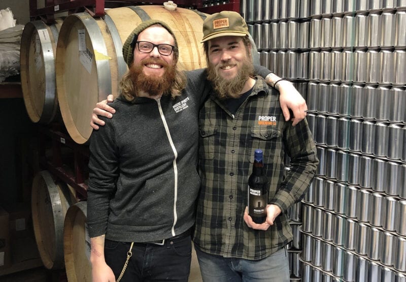 Brewers Jeff Bunk, left, and Jack Kern release Proper Brewing Co.'s first barrel-aged beer — Monolith.