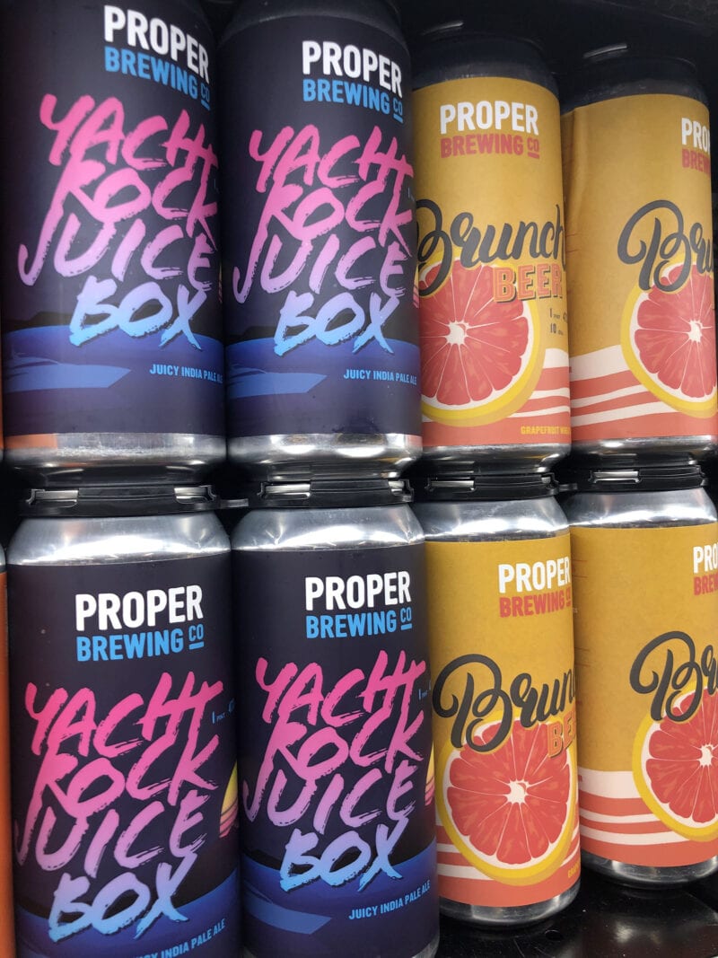 Proper Brewing beers on grocery store shelves in 16-ounce cans.