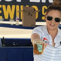 Rebecca Cardaccio, sales director for Proper Brewing Co. in Salt Lake City, serves a beer at the Utah Beer Festival in 2019.