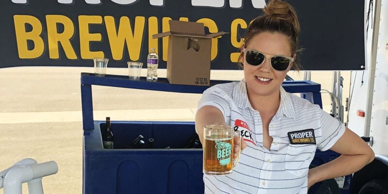 Rebecca Cardaccio, sales director for Proper Brewing Co. in Salt Lake City, serves a beer at the Utah Beer Festival in 2019.